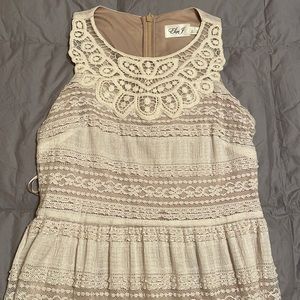 Floor length, cream, and lace dress.